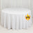 Round white table with a draped tablecloth