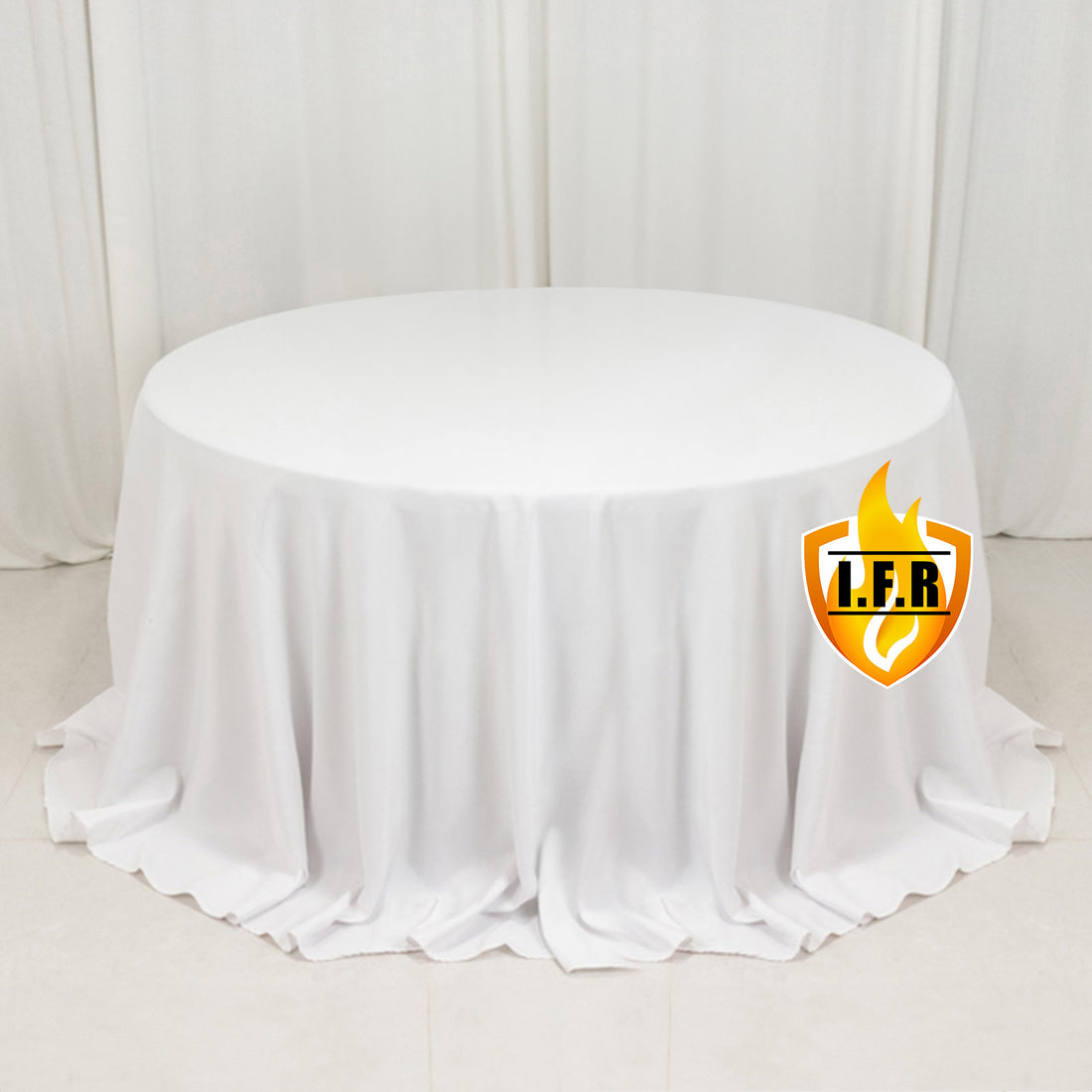 White round table with a draped tablecloth, suitable for events or dining.