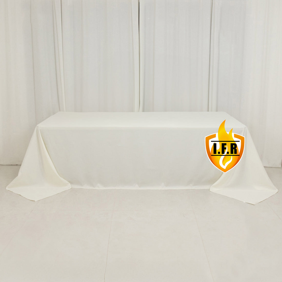 White tablecloth draped on a table with logo in the corner