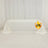 White tablecloth draped on a table with logo in the corner