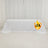 White table cover with logo on a plain backdrop