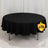 Round black table with tablecloth for events and gatherings.