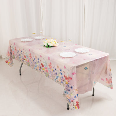 Floral-patterned tablecloth on a folding table with white plates