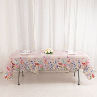 Floral-patterned tablecloth draped over a table with decorative plates and a bouquet.