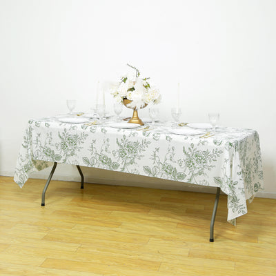 Floral-patterned tablecloth draped over a table with elegant dining setup.