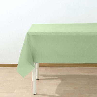 Green tablecloth draped over a table in a bright setting.
