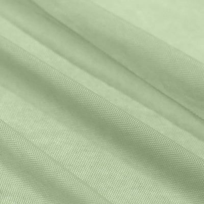 Light green textured fabric draped elegantly in soft folds.