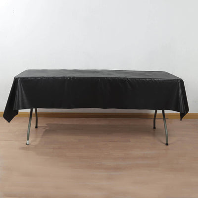 Black tablecloth draped over a table in a studio setting.