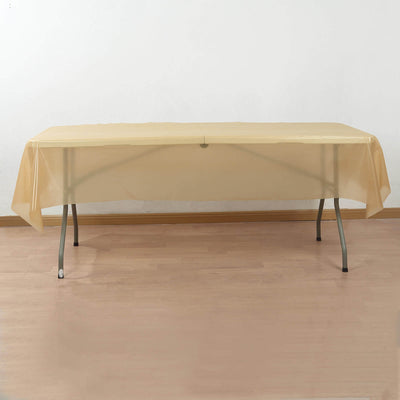 Beige table cover draped over a folding table on light wooden floor.