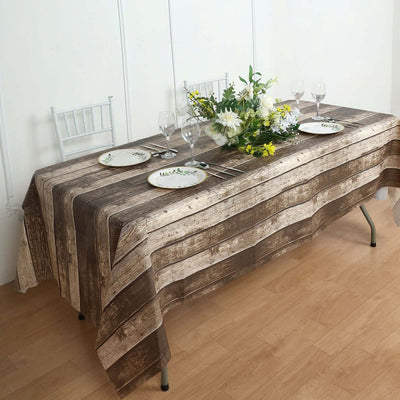 Wooden plank tablecloth on a dining table with floral centerpiece and dinnerware.