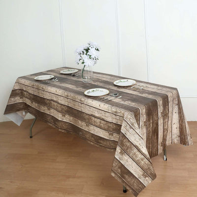Rustic wooden tablecloth on a dining table with plates and a vase of flowers.
