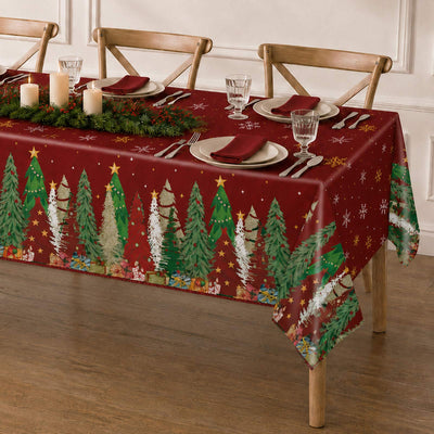 Christmas dining table with red holiday tablecloth, candles, and place settings