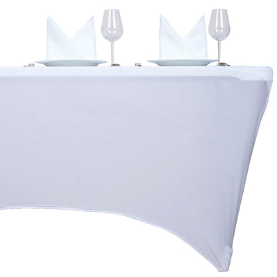White tablecloth set for dining with plates and glasses