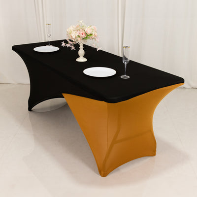 Black and gold table cover with floral centerpiece and dinnerware setup.