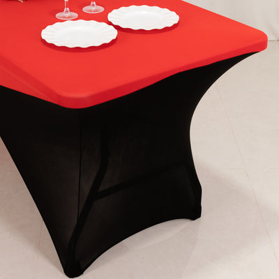 Elegant black and red table with decorative plates and glasses.