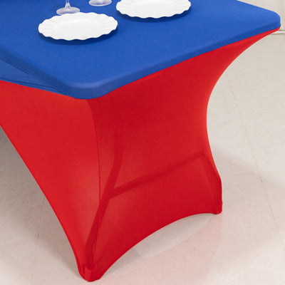 Red and blue table cover on a table with white plates.
