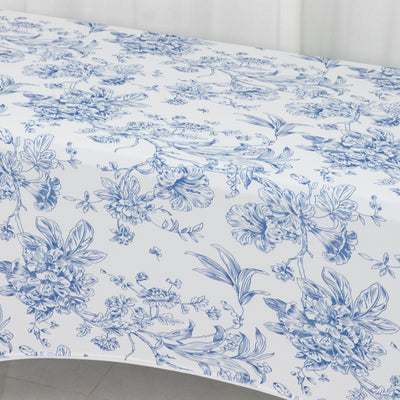 Blue floral tablecloth on a white surface.