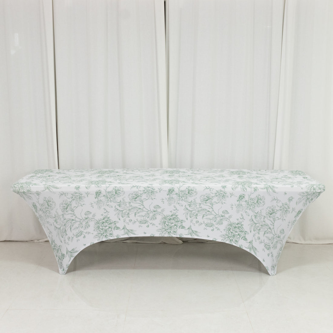 Floral-patterned table cover on a bench against a plain backdrop