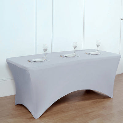Gray fitted table cover with plates and glasses set for dining