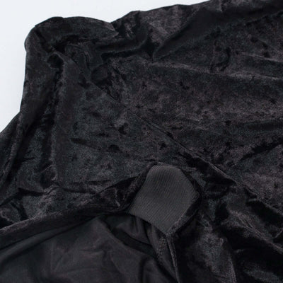 Black velvet fabric texture with smooth lining detail.