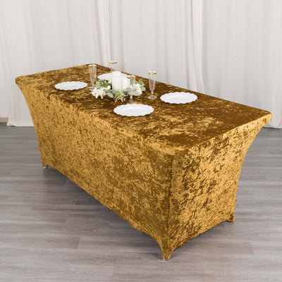 Gold velvet table cover with elegant décor set for an event.