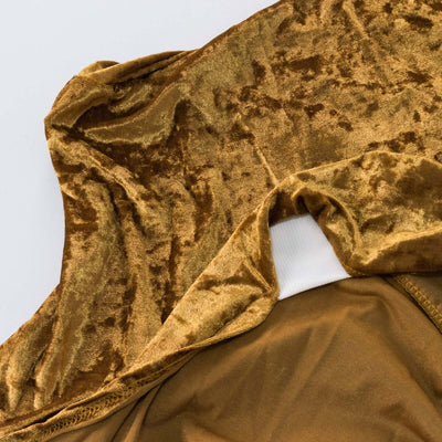 Gold velvet fabric close-up showcasing texture and sheen.