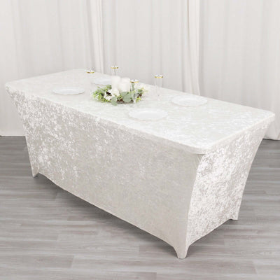 Elegant white tablecloth draped over a rectangular table with a floral centerpiece.