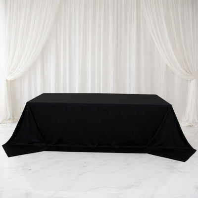 Black table cover draped elegantly over a table in a staged setting.