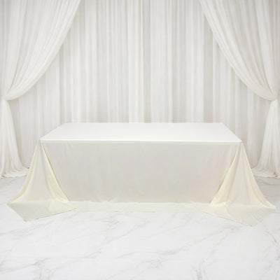 White tablecloth draped elegantly over a table in a studio setting.