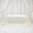 White tablecloth draped elegantly over a table in a studio setting.