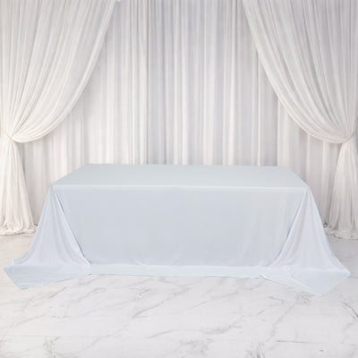 White tablecloth draped over a table, set against a soft, elegant backdrop.