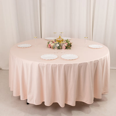 Round table set with pink tablecloth and decorative centerpiece