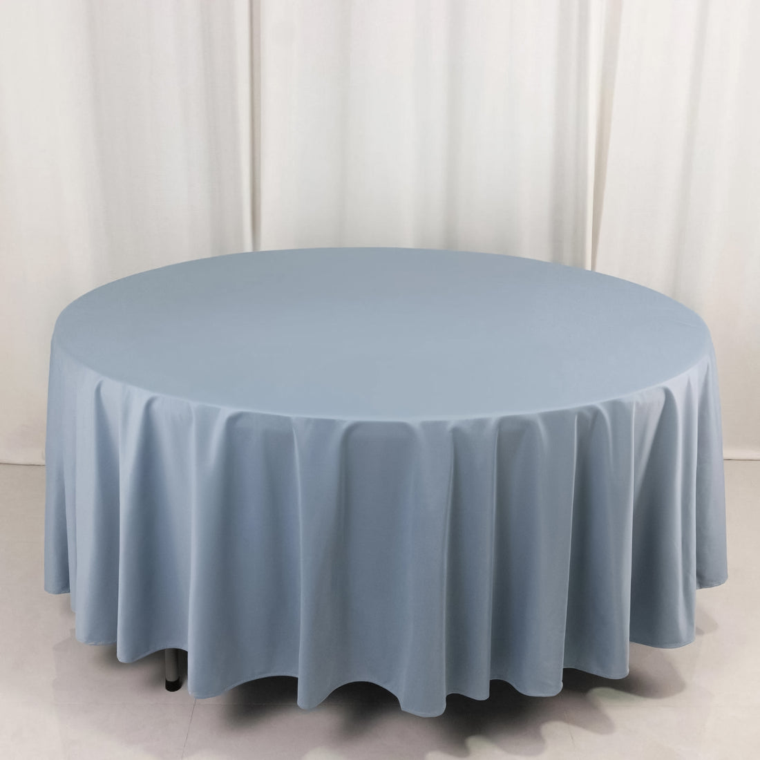 Round blue tablecloth on a white backdrop.