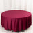 Round burgundy tablecloth on a plain backdrop