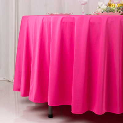 Bright pink tablecloth draping over a table, ideal for events or decor.
