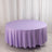 Round lavender tablecloth draped elegantly over a circular table.