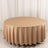 Round beige tablecloth on a circular table, smooth fabric draping elegantly.