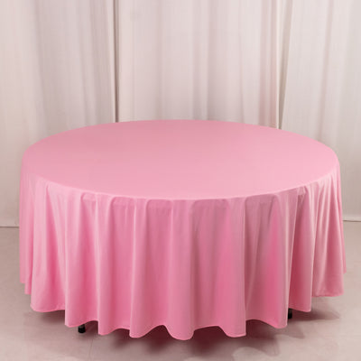Round pink tablecloth draped elegantly over a table.
