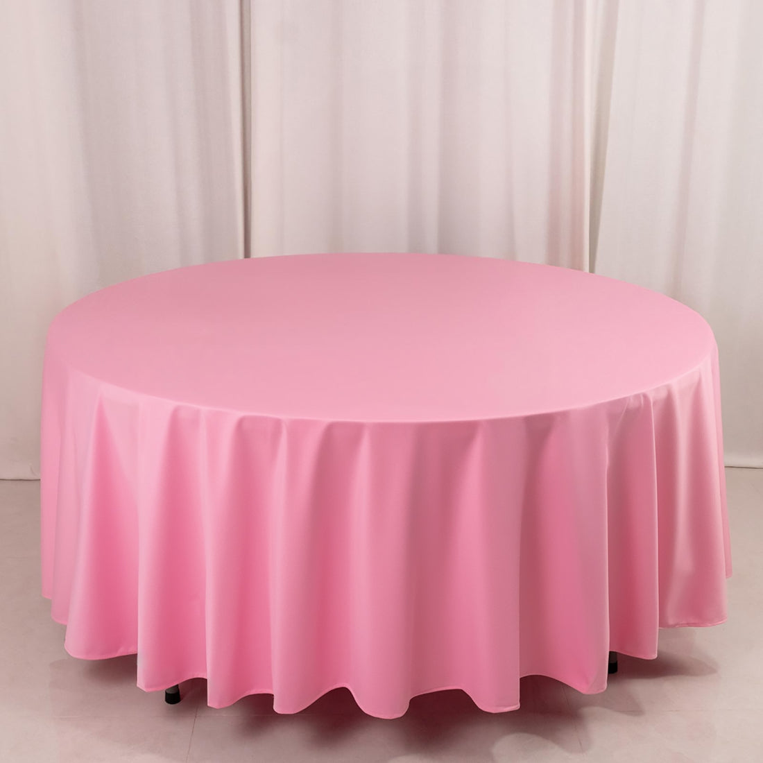 Round pink tablecloth draped elegantly over a table