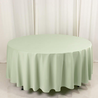Round mint green tablecloth on a white backdrop