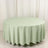 Round mint green tablecloth on a white backdrop