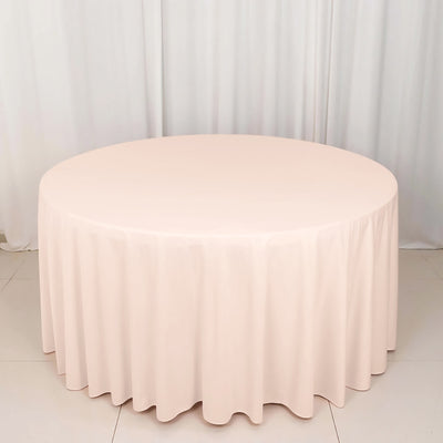 Round pink tablecloth on a circular table.