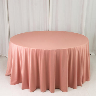 Round blush pink tablecloth on table in studio setting