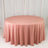 Round blush pink tablecloth on table in studio setting
