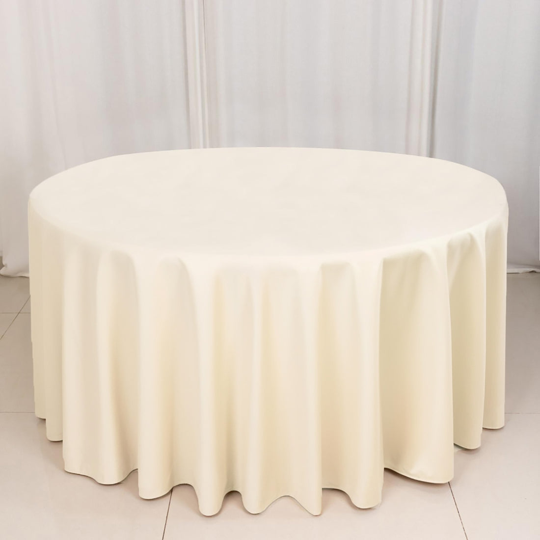 Cream tablecloth draped elegantly over an oval table.