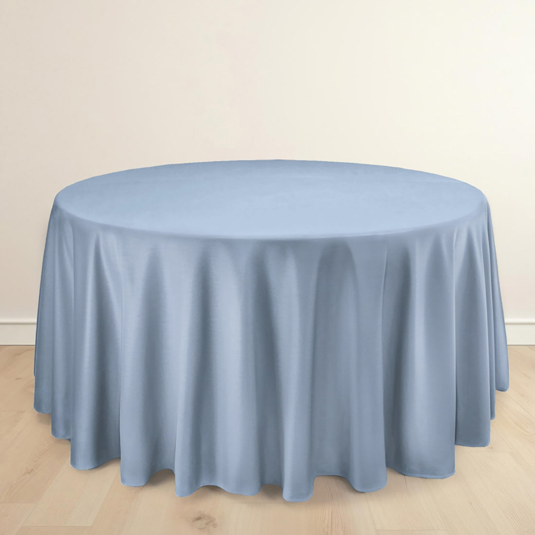 Light blue tablecloth on a round table against a plain background.