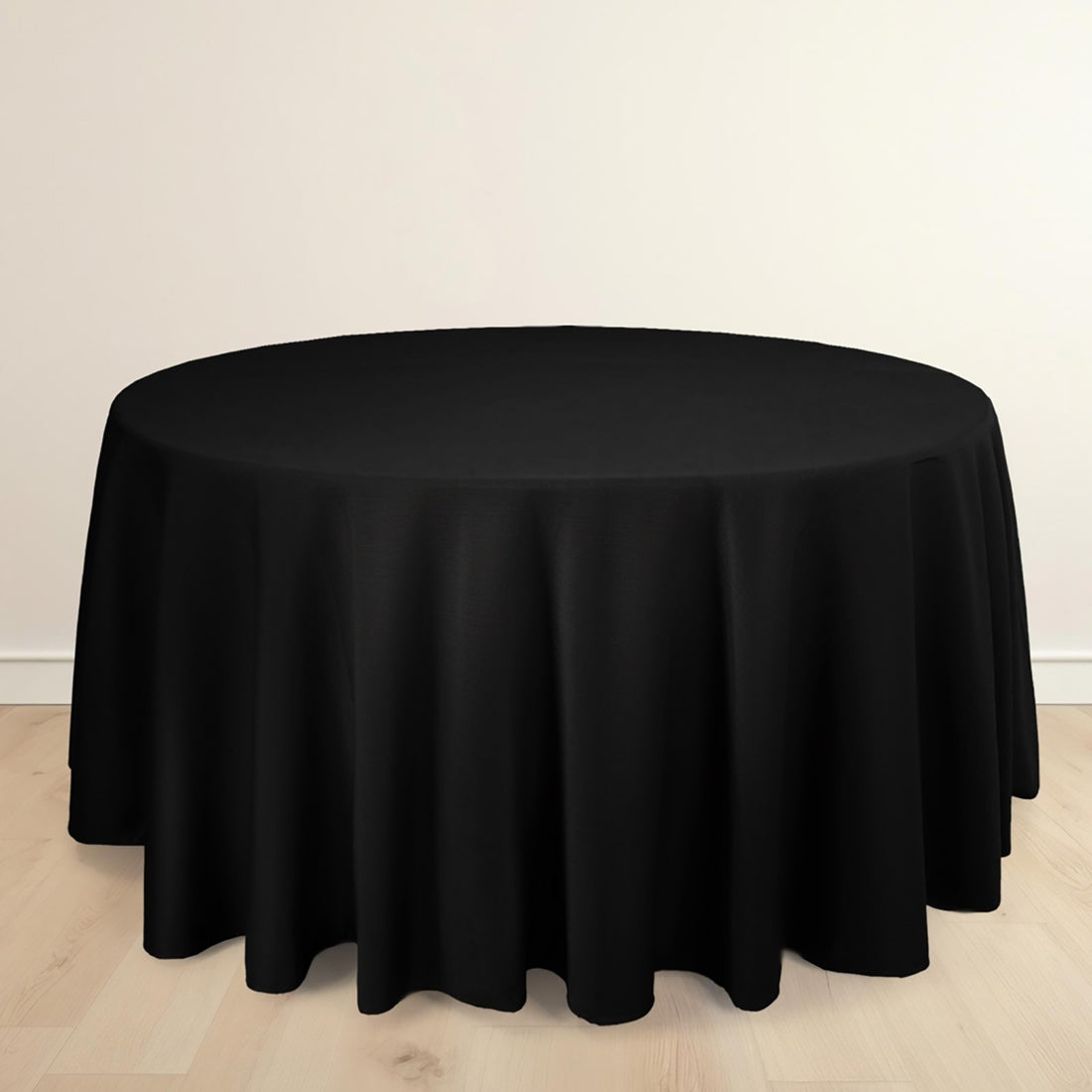 Round black tablecloth draped over a circular table.