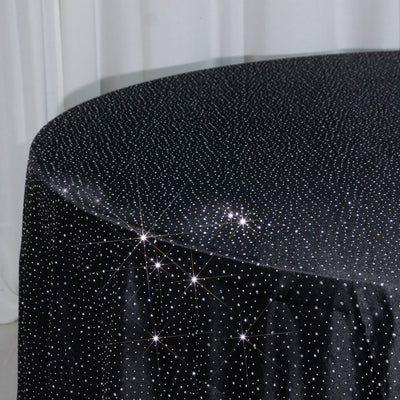Black tablecloth adorned with sparkling rhinestones.