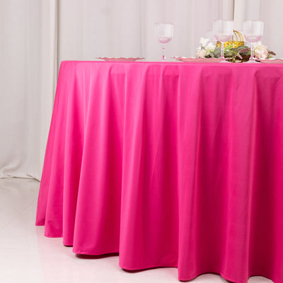Pink tablecloth draping over a table in a styled setting.