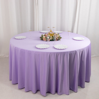 Round lavender tablecloth with white plates and floral centerpiece.